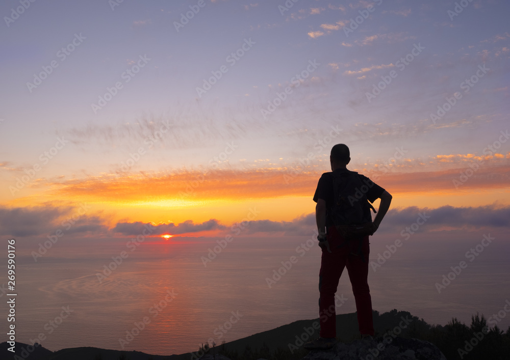 homber doing sports on the top, facing the blue sky and the sunset on the sea, Euskadi homber doing sports on the top, facing the blue sky and the sunset on the sea, Euskadi