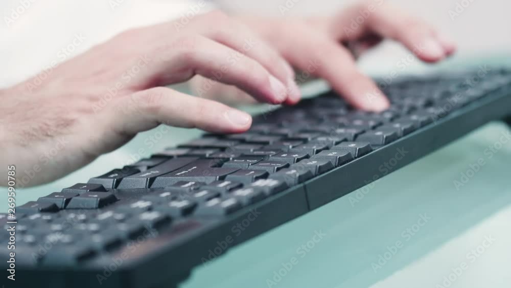 Very close up shot of doctor hands typing on computer keyboard on a modern glass desk. Dolly parallax footage Very close up shot of doctor hands typing on computer keyboard on a modern glass desk. Dolly parallax footage