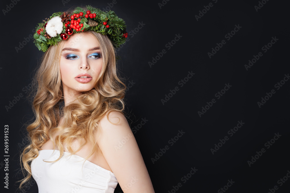 Pretty woman in green fir crown on black background Pretty woman in green fir crown on black background