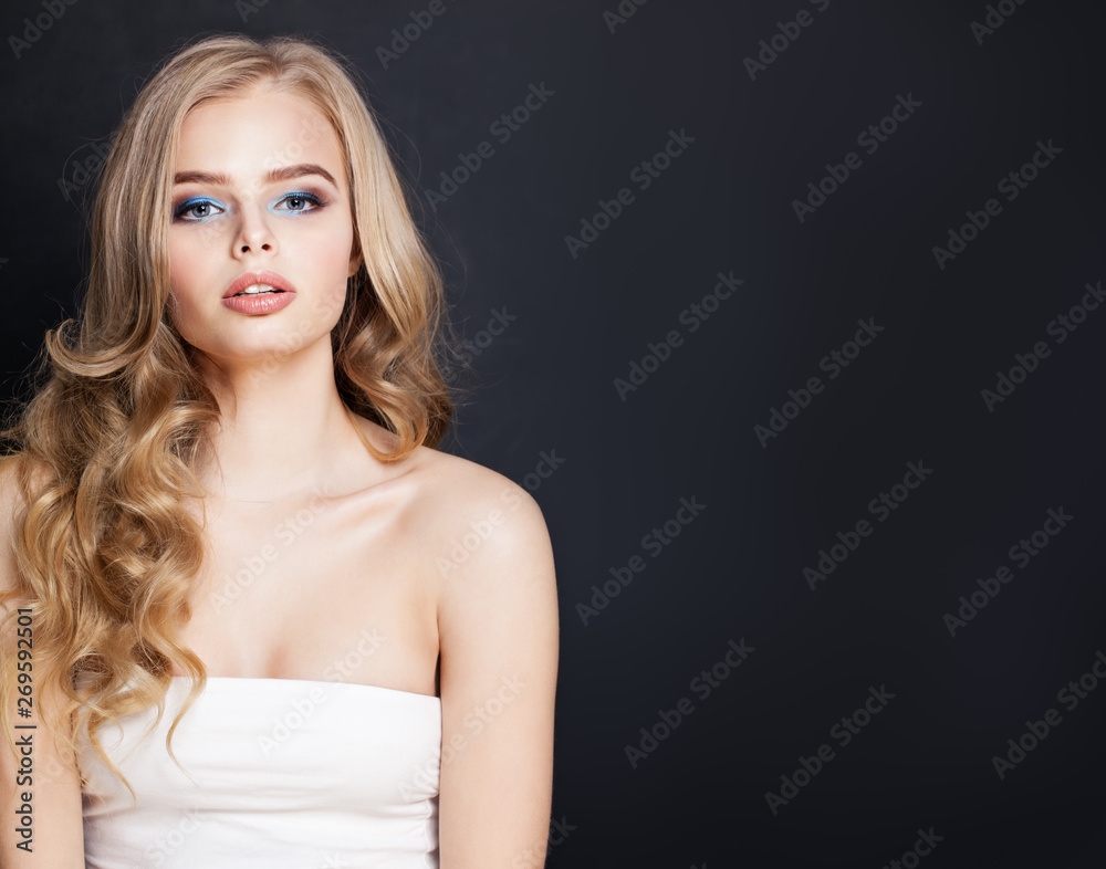 Perfect blonde woman with long hair on black background