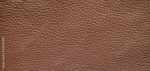 Natural background with brown leather of a rough texture.