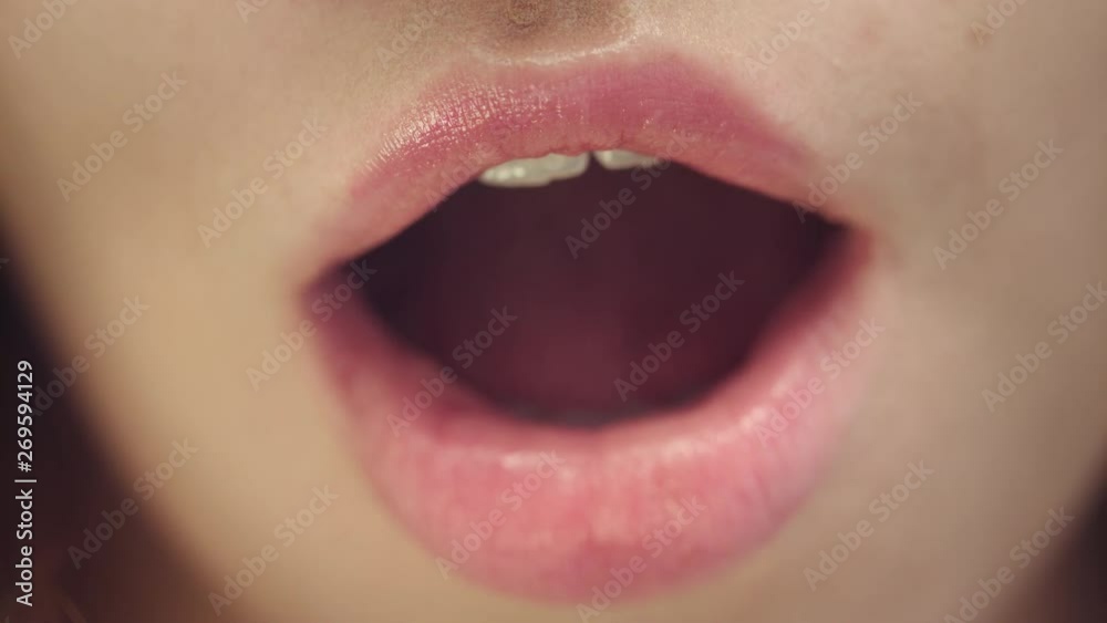 Female face of attractive woman with opened mouth. Sexy and plump female lips