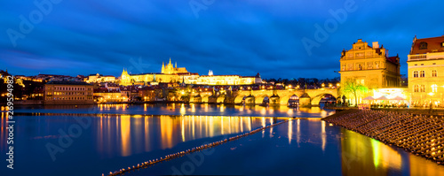 Charles Bridge over Vltava river in Prague, Czech Republic. Night with touristic boats