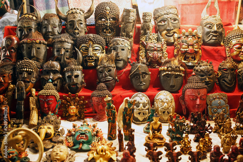 Colorful carved masks are sold, colored masks of different perfumes hang on the wall.