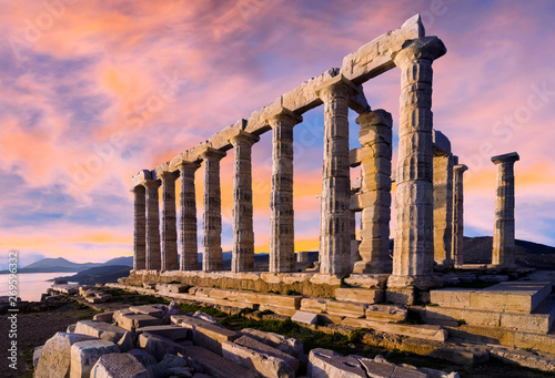 Sounion, Attica / Greece. The Temple of Poseidon at cape Sounion. Colorful sunset with beautiful cloudy sky. Golden hour photo