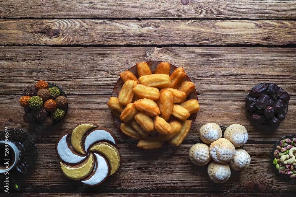 Ramadan sweets on a wooden table. Top view. Ramadan sweets on a wooden table. Top view.