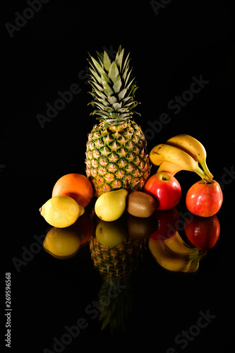 Fresh fruits reflect on black background. Isolated fruits