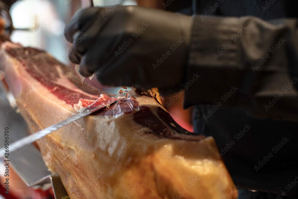 cutting and serving Spanish Iberian ham