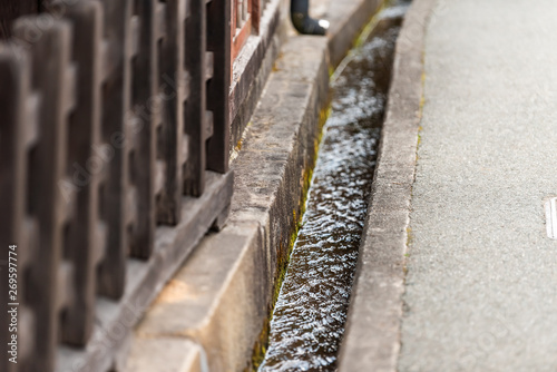 Fototapeta Naklejka Na Ścianę i Meble -  Takayama, Japan small canal gutters in Gifu prefecture closeup view of river in mountains in city