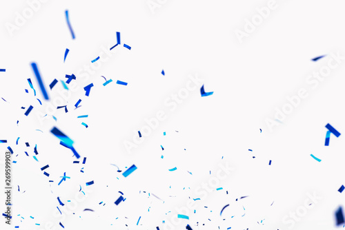 Confetti from crackers. Blue elements on a white background. Shot of confetti at a party. Festive mood. Serpentine, festive decor