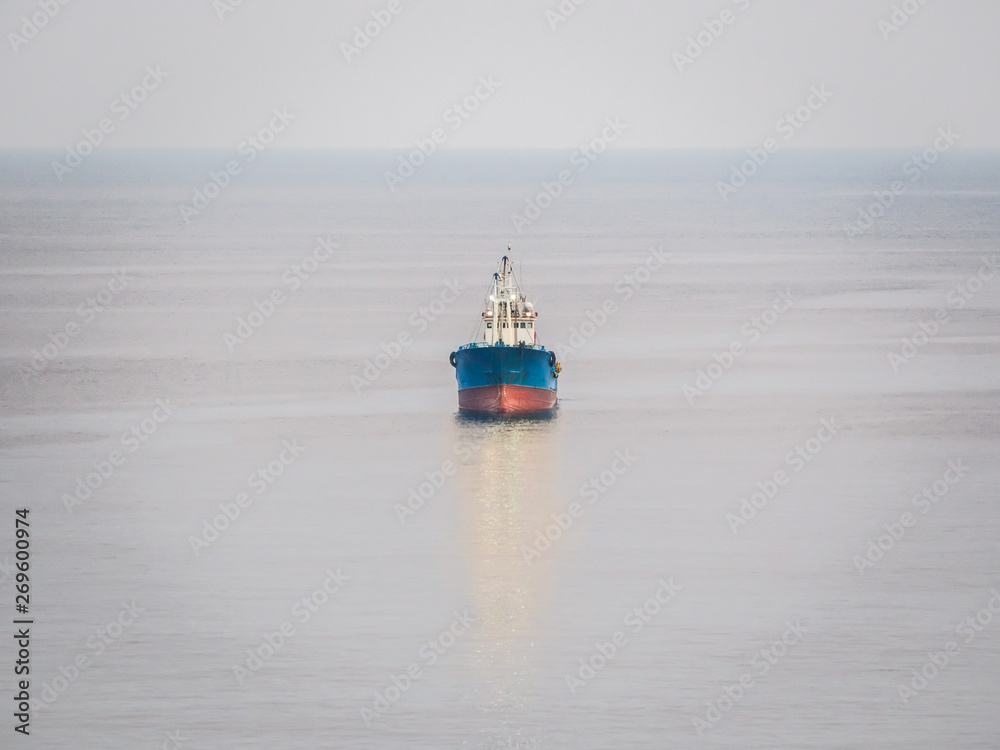 The cargo ship is traveling in the ocean. The cargo ship is traveling in the ocean.