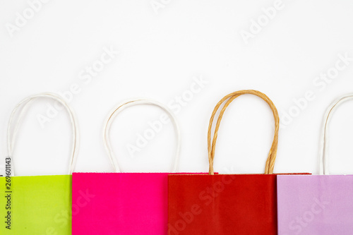 Set of different colour shopping paper bags on a white background, top view, flat