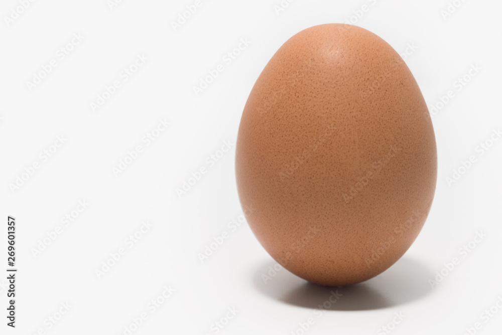 One egg on a white background, Closeup with space to the left. Isolated. One egg on a white background, Closeup with space to the left. Isolated.