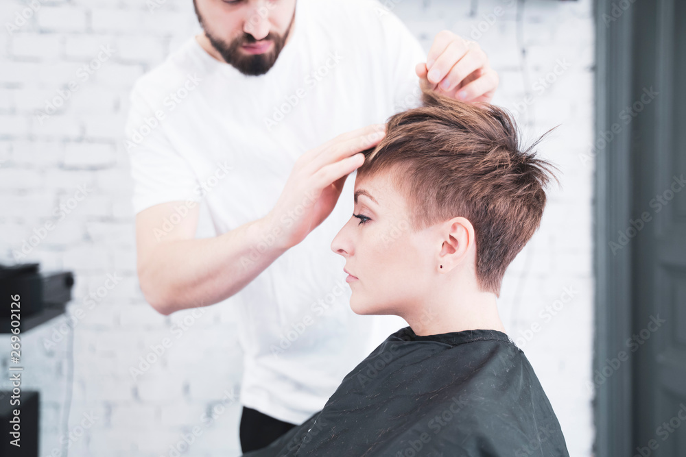 Hairdresser combing the woman's fingers Hairdresser combing the woman's fingers