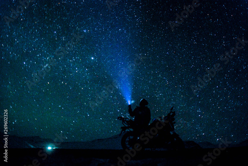 Biker under stars in winter spiti - himalayas