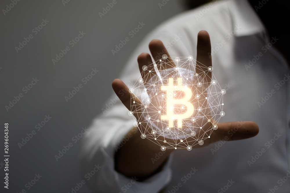 Image virtual reality,Cryptocurrency golden bitcoin coin. Man holding in hand symbol of crypto currency - electronic virtual money for web banking and international network payment - obrazy, fototapety, plakaty 