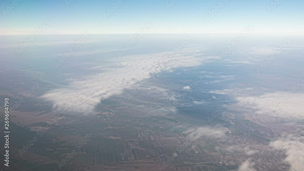 Airplane window view, fly above clouds Airplane window view, fly above clouds