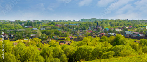 Panoramic view of Inzhavino village in Voroninsky National Park, Tambov Oblast, Russia. River, trees and the field on a sunny summer day.