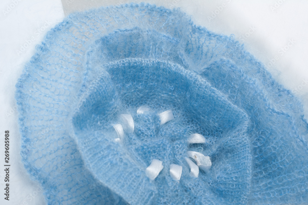 Fototapeta premium Knitting mohair wool and knitting needles for handmade on wooden table. Blue Flower.