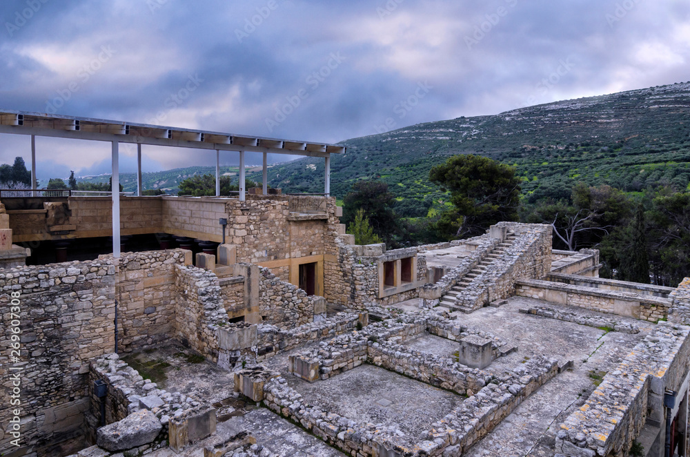 Knossos Palace, Crete / Greece. View of the archaeological site of Knossos in Heraklion at sunset. Cloudy sky