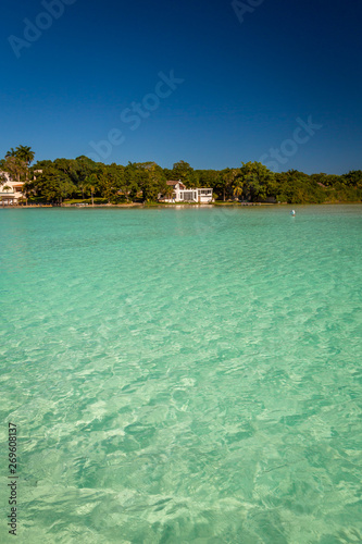 Laguna de Bacalar aka as the Lagoon of Seven Colors, Mexico. The crystal clear waters and white sandy bottom of the lake cause the water color to morph into varying shades of turquoise and blue.