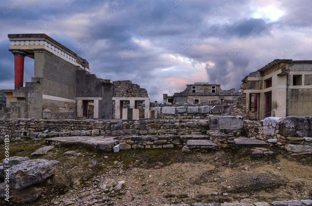 Knossos, Crete - Greece. Knossos Palace at the archaeological site of Knossos which is the largest Bronze Age archaeological site on Crete and has been called Europe's oldest city. Sunset, cloudy sky