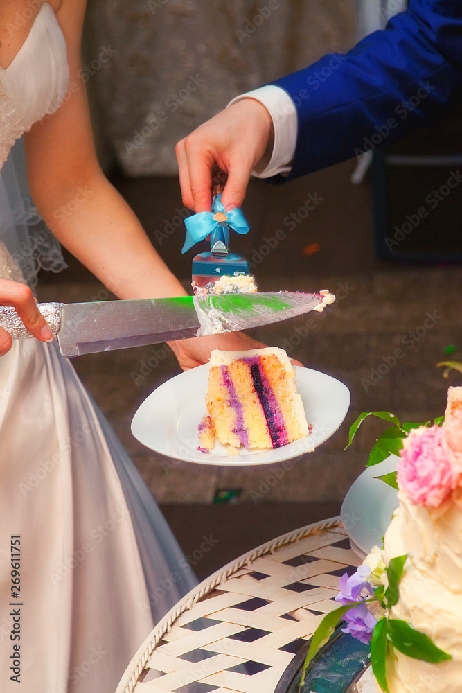 the bride and groom cut off a piece of wedding cake