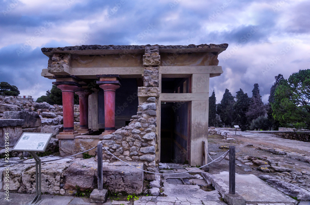 Naklejka premium Knossos, Crete - Greece. The North Lustral Basin room at the archaeological site of knossos resembles a cistern. Its floor is lower than the surrounded area and is reached by steps. Sunset, cloudy sky