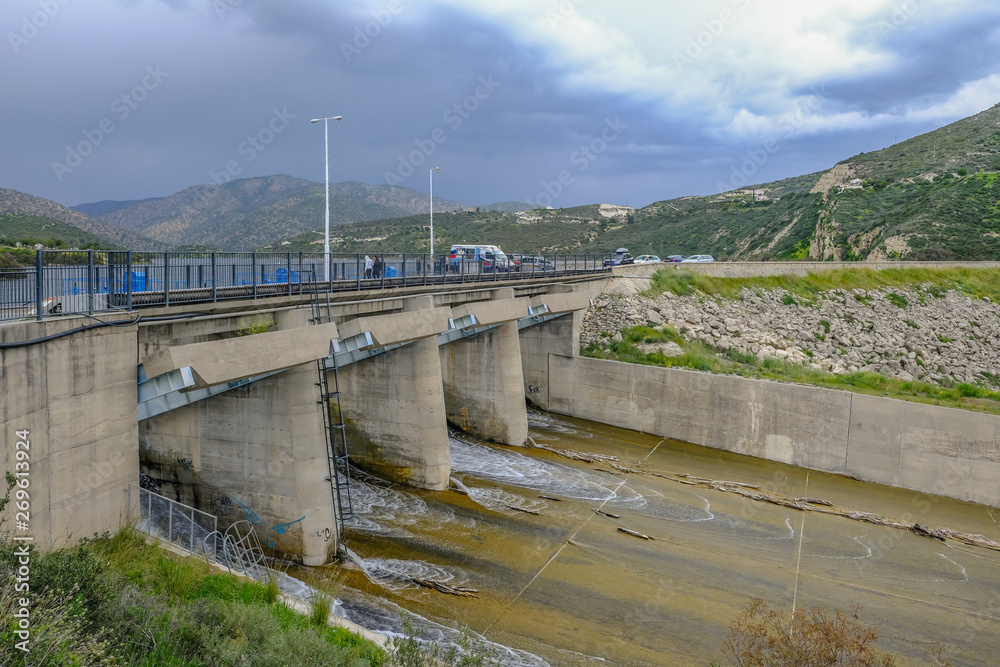 View of Germasogeia dam's overflow in spring when the water is gushing out of the reservoir.