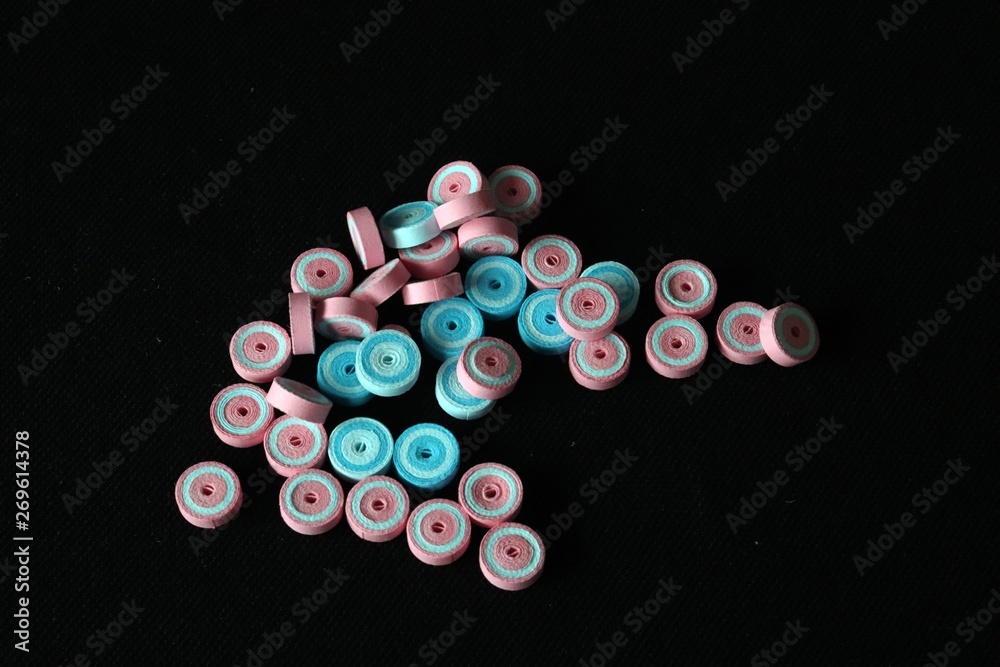 Pink and Blue paper quilled tight coil circles against black background Pink and Blue paper quilled tight coil circles against black background