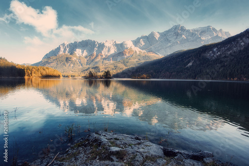 Impressive Autumn landscape The Eibsee Lake in front of the Zugspitze under sunlight. Amazing sunny day on the mountain lake. concept of an ideal resting place. Eibsee lake in Bavaria, Germany