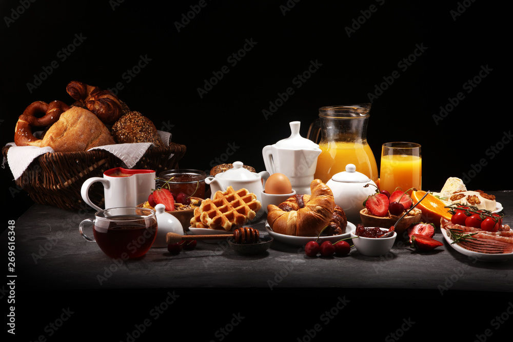 Huge healthy breakfast on table with coffee, orange juice, fruits, waffles and croissants. Good morning concept. Huge healthy breakfast on table with coffee, orange juice, fruits, waffles and croissants. Good morning concept.