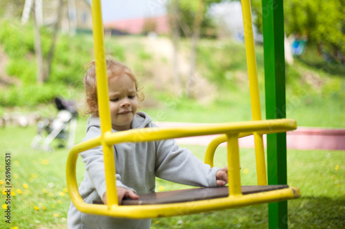 the little girl is nervous because she can't climb the swing