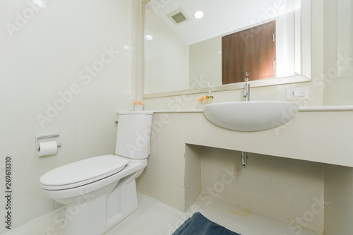 Condo bathroom design with single vanity cabinet and grey tiles on the walls.