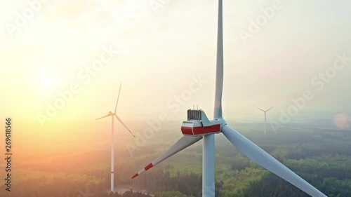 AERIAL 4K / Ultra HD - Birds eye view on Wind Power, Turbine, Windmill, Energy Production at sunrise - Clean and Renewable Energy  photo