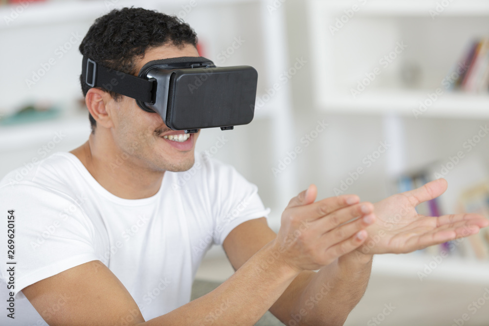 bearded man using the virtual reality headset and two controller bearded man using the virtual reality headset and two controller