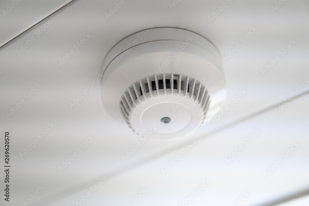 smoke detector and fire sensor on a ceiling. smoke detector and fire sensor on a ceiling.