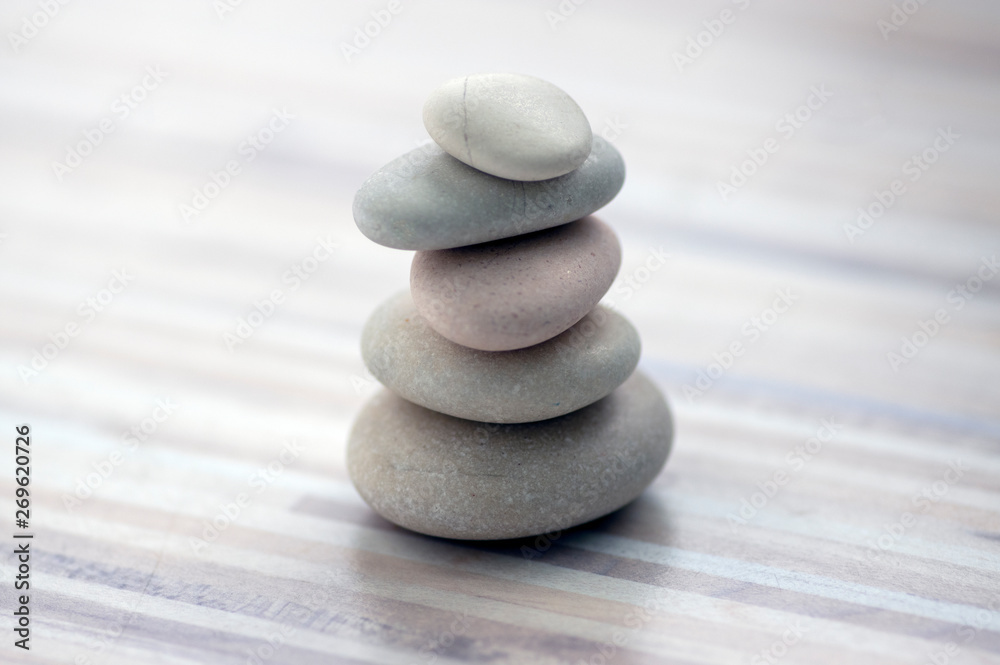 Harmony and balance, cairns, simple poise stones on wooden light white gray background, simplicity rock zen sculpture