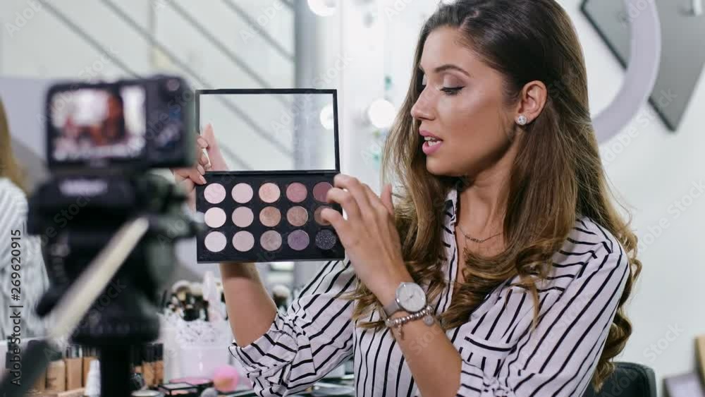 Young female blogger making a video for her beauty blog on cosmetics.