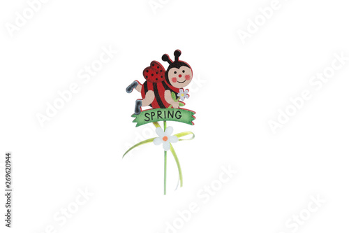 A wooden figure of a spring ladybug on a white background