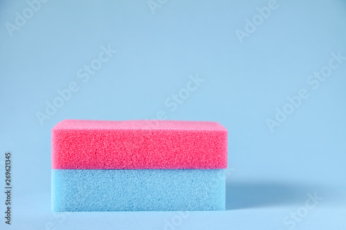 Colorful washcloths on a blue background. Accessories for body care and hygiene.