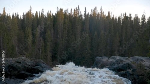 Finnish waterfall, a static shot of the stream, from the top of Hepokongas falls, on a sunny, spring day, in Puolanka, Kainuu region,  Finland 50fps, photo