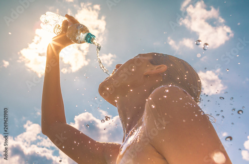 Woman drinking cooling off in the summer heat  photo