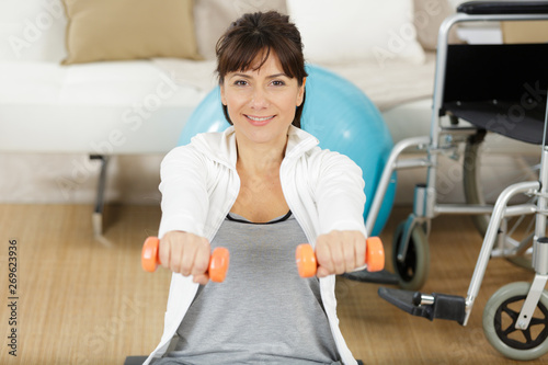 young pretty disable woman exercising at home