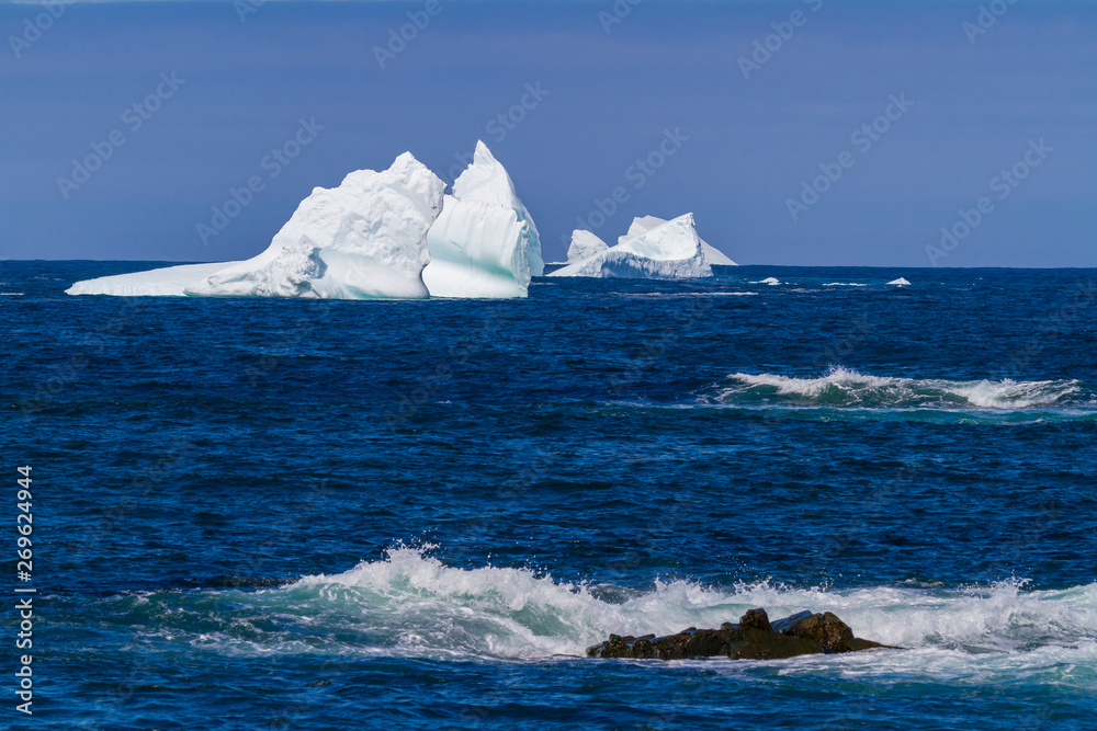 An iceberg along the Newfoundland coastline in summer, very popular with tourist. An iceberg along the Newfoundland coastline in summer, very popular with tourist.