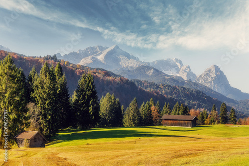 Stunning landscape at Alpine valley. Awesome sunny day in the Bavarian Alps with perfect sky under sunlit. Incredible European alps in Germany. Zugspitze on background. Wonderful natural Background