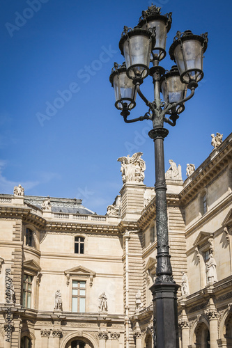 Architectural facade of the aisles and the lamps of the place of the pyramids of the Louvre museum in Paris - Paris, France