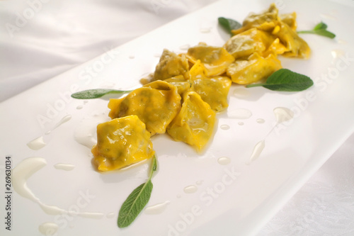 Italian food recipes, fresh stuffed pasta Agnolotti del plin with butter and sage sauce.