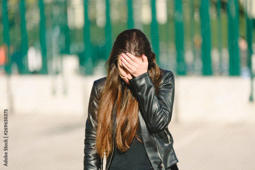 Fototapeta premium Sad teen girl millennial woman feeling heartbroken at phone, depressed upset by bad news in mobile feeling anxious.