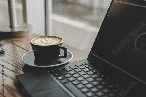 latte and laptop on table